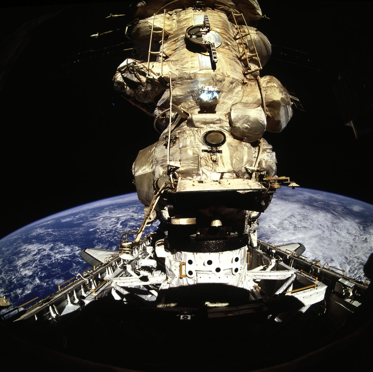 STS071-723-033 (29 June 1995) --- The hard dock finalizing the June 29, 1995, link-up of the Russian Mir Space Station and the space shuttle Atlantis was documented with a 70mm handheld camera from the aft flight deck of the Space Shuttle Atlantis. The Androgynous Peripheral Docking System (APDS) and the Kristall module on Mir are at center frame. Later, five NASA astronauts and two Russian cosmonauts boarded Mir. The occasion was just two and a half weeks prior to the 20th anniversary of the Apollo-Soyuz Test Project (ASTP) docking in Earth-orbit.