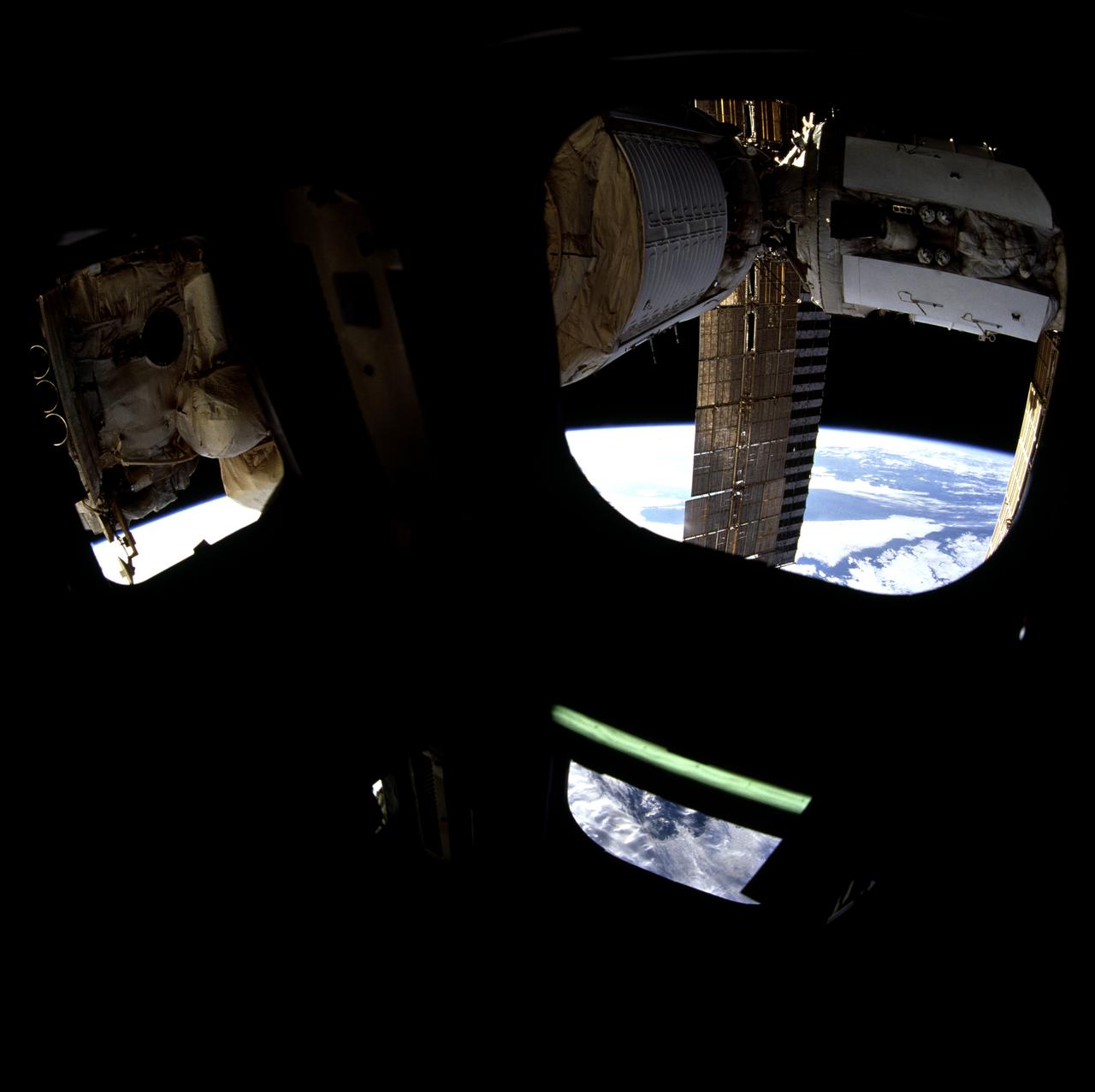 STS071-723-045 (27 June-7 July 1995) --- Docked already with the Space Shuttle Atlantis, Russia's towering Mir Space Station is partially visible through windows on the silhouetted ceiling of the space shuttle Atlantis' aft flight deck.  A 70mm camera was used to expose the image.
