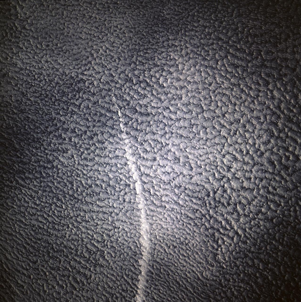 STS071-745-006 (27 June-7 July 1995) --- This view shows a ship track, probably in the northern Pacific Ocean, where a ship has caused clouds to form more thickly directly above the path of this ship. This track is therefore visible even though the ship itself is not. Ship tracks are thought to be caused by particles thrown up into the air by the ship, from smokestack emissions and from water particles generated by the ship moving through the sea. Under favorable weather conditions, water condenses around these particles to form clouds, in this case thicker "popcorn" clouds than already exists in the area. Ongoing studies are attempting to understand this phenomenon better.