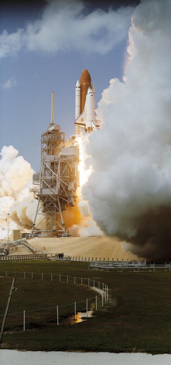 STS071-S-005 (27 June 1995) --- At the Kennedy Space Center's (KSC) Launch Pad 39A, the 100th United States human space launch gets underway at 3:32:19 p.m. (EDT) on June 27, 1995.  Onboard Atlantis are five NASA astronauts and two Russian cosmonauts.  In two days, the crew will join up with astronaut Norman E. Thagard and two Russian cosmonauts who have been onboard Russia's Mir Space Station since March of this year.  That pair - Vladimir N. Dezhurov and Gennadiy M. Strekalov - will return to Earth aboard the Space Shuttle Atlantis with Thagard and the short-term visitors, while Anatoly Y. Solovyev and Nikolai M. Budarin - the two cosmonauts launched today aboard the Space Shuttle Atlantis - will remain aboard Mir for a longer tour of duty.