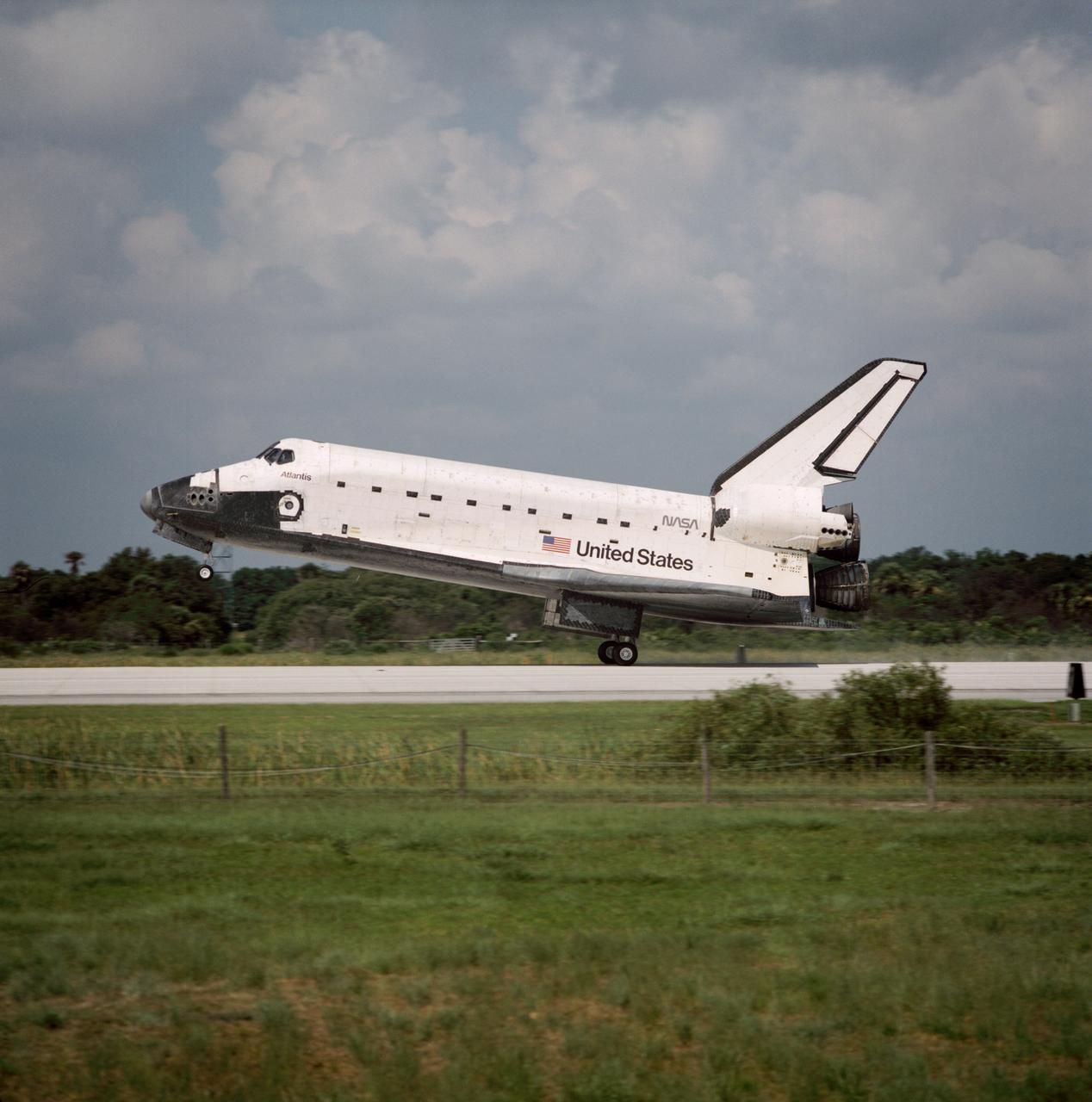 STS071-S-069 (7 July 1995) --- The Space Shuttle Atlantis touches down on Runway 33 at the Kennedy Space Center's (KSC) Shuttle landing facility to complete an historic mission in space.  The landing completed an historic mission in space involving a linkup with Russia?s Mir Space Station and a total of six astronauts and four cosmonauts.  Onboard for the landing were six NASA astronauts and two cosmonauts.  Touchdown occurred at 10:55 a.m. (EDT), July 7, 1995.