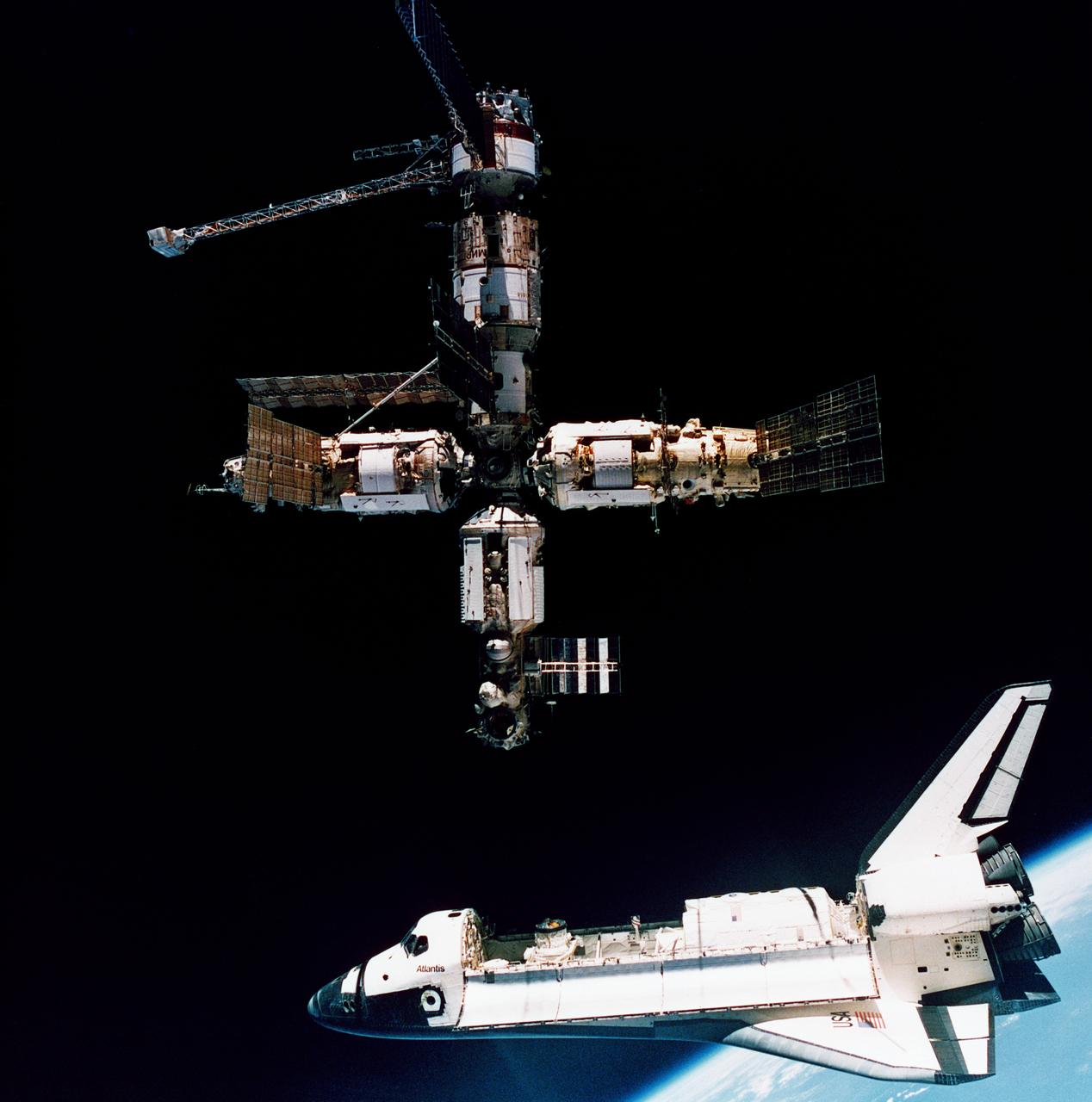 STS071-S-075 (4 July 1995) --- This view of the space shuttle Atlantis beginning its move away from Russia's Mir Space Station was photographed by the Mir-19 crew on July 4, 1995. Cosmonauts Anatoliy Y. Solovyev and Nikolai M. Budarin, Mir-19 commander and flight engineer, respectively, temporarily undocked the Soyuz spacecraft from the cluster of Mir elements to perform a brief fly-around. They took pictures while the STS-71 crew, with Mir-18's three crew members aboard, undocked from Atlantis for the completion of this leg of the joint activities. Solovyev and Budarin had been taxied to the Mir Space Station by the STS-71 ascent trip of Atlantis.