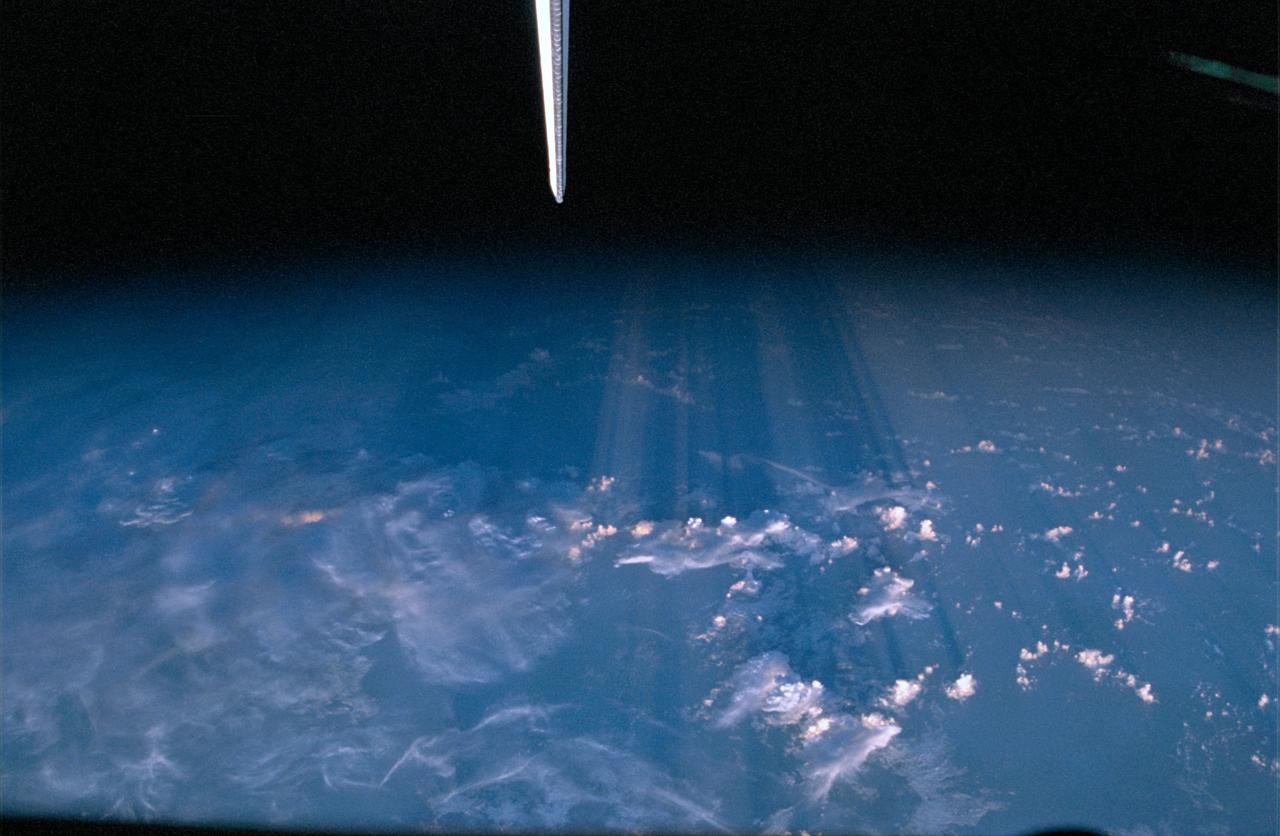 STS072-308-033 (11-20 Jan. 1996) --- The vertical stabilizer of the Space Shuttle Endeavour almost appears to be pointing out the odd phenomenon of sun streaks and shadows on clouds over the southwestern United States. This was one of seventeen still images shown by the crew members for NASA employees and guests following their stay in space aboard the Endeavour.