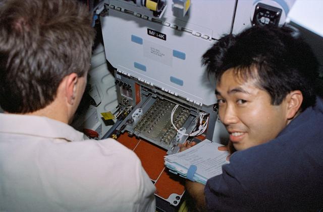 NASA image: Astronauts Brent Jett and Koichi Wakata work with Protein Crystal Growth experiment