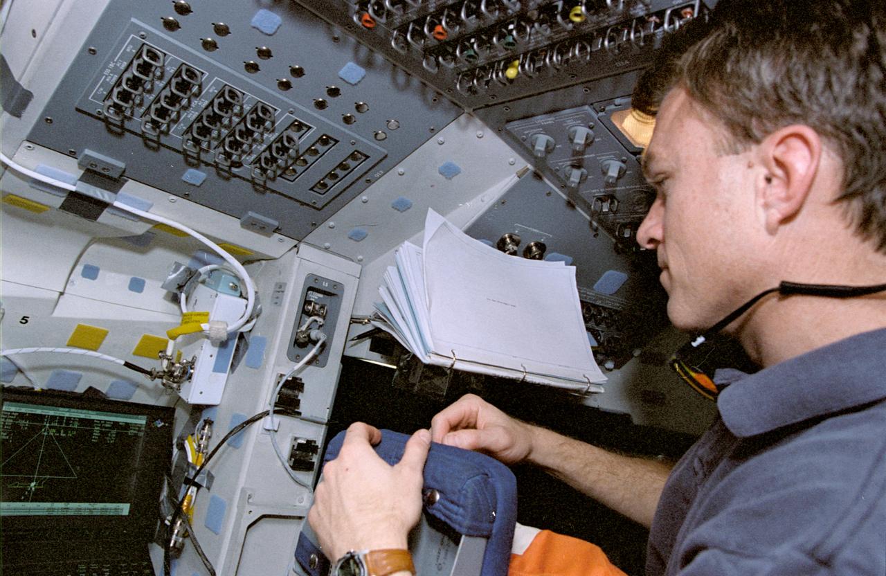 STS072-349-018 (11-20 Jan. 1996) --- On the Space Shuttle Endeavour’s flight deck, astronaut Brett W. Jett Jr., pilot, monitors display of software dealing with proximity operations with one of two satellites.  The crew retrieved the Japanese Space Flyer (SFU) and berthed in the aft cargo bay, as well as releasing and re-capturing the Office of Aeronautics and Space Technology (OAST) Flyer satellite.