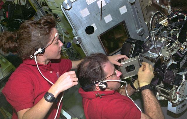 STS073-108-005 (20 October-5 November 1995) --- Two members of the crew perform an in-flight maintenance on the Drop Physics Module (DPM) in the science module aboard the Earth-orbiting Space Shuttle Columbia.  Payload commander Kathryn C. Thornton and payload specialist Albert Sacco Jr. were part of a seven-member crew that spent 16 full days in space in support of the United States Microgravity Laboratory (USML-2) mission.
