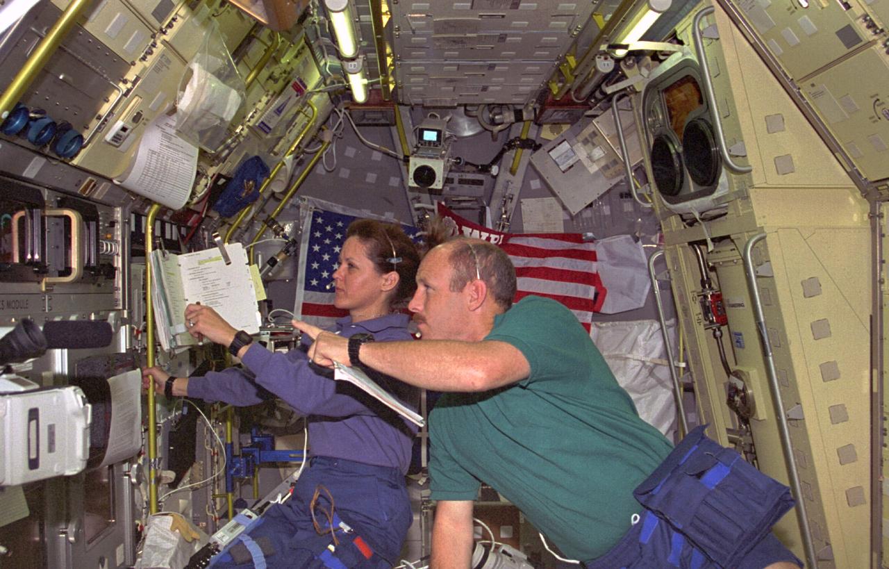 STS073-229-014 (20 October - 5 November 1995) --- Astronauts Kathryn C. Thornton, STS-73 payload commander, and Kenneth D. Bowersox, mission commander, observe a liquid drop's activity at the Drop Physics Module (DPM) in the science module aboard the Earth-orbiting Space Shuttle Columbia.  The drop is partially visible at the center of the left edge of the frame.  The two were joined by three other NASA astronauts and two guest researchers for almost 16-days of in-orbit research in support of the U.S. Microgravity Laboratory (USML-2) mission.