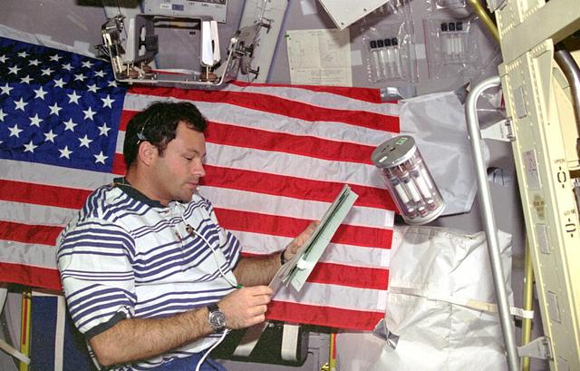 STS073-232-013 (20 October - 5 November 1995) --- Astronaut Michael E. Lopez-Alegria, STS-73 mission specialist, checks notes related to the Commercial Generic Bioprocessing Apparatus (CGBA) aboard the Earth-orbiting Space Shuttle Columbia.  CGBA supported over one hundred individual experiments on small quantities of samples ranging from molecules to small organisms.  Lopez-Alegria joined four other NASA astronauts and two guest researchers for 16-days of United States Microgravity Laboratory 2 (USML-2) research aboard the Space Shuttle Columbia.