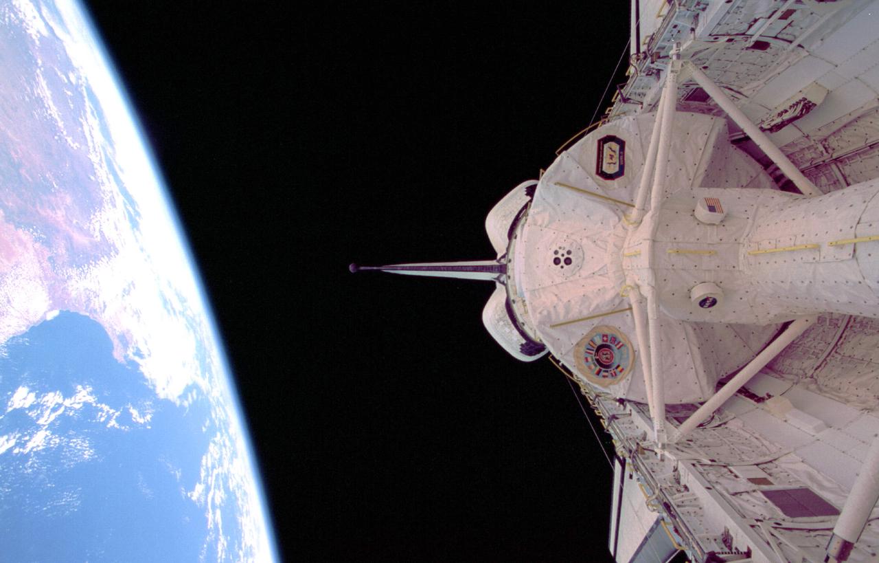 STS073-326-021 (20 October - 5 November 1995) --- The darkness of space and the Atlantic coast of southern Africa form the backdrop for this scene.  Five NASA astronauts and two guest researchers spent almost 16 days of research in this science module affixed in the payload bay of the Space Shuttle Columbia in Earth-orbit.  The tunnel in bottom foreground served as the busy passageway for the seven crew members, who split their forces into two shifts.  South Africa and the Cape of Good Hope are the dominant features that can be delineated in the Earth scene.