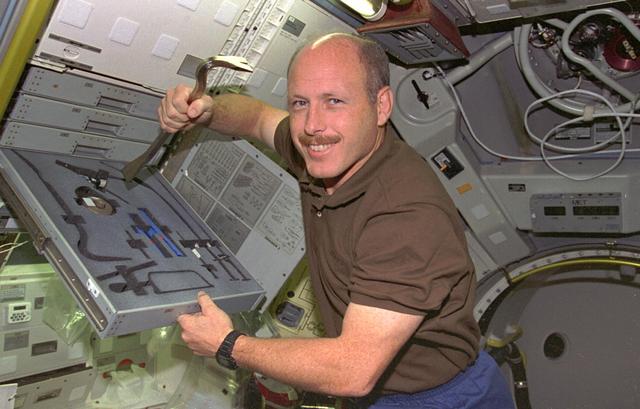 STS073-351-024 (20 October - 5 November 1995) --- Astronaut Kenneth D. Bowersox, STS-73 mission commander, retrieves a crow bar from a tool set onboard the science module in the cargo bay of the Earth-orbiting Space Shuttle Columbia.  Various tools were available for a variety of in-flight maintenance tasks for the crew to carry out during the 16-day United States Microgravity Laboratory (USML-2) mission.
