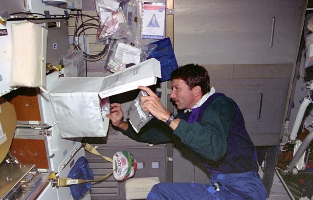 NASA image: DSO 611, Pilot Kent Rominger samples air in crew compartment middeck