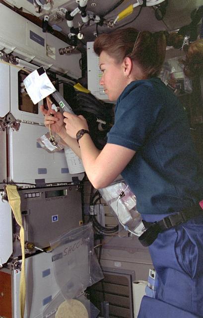 NASA image: ASC, Mission Specialist Catherine "Cady" Coleman works with middeck experiment