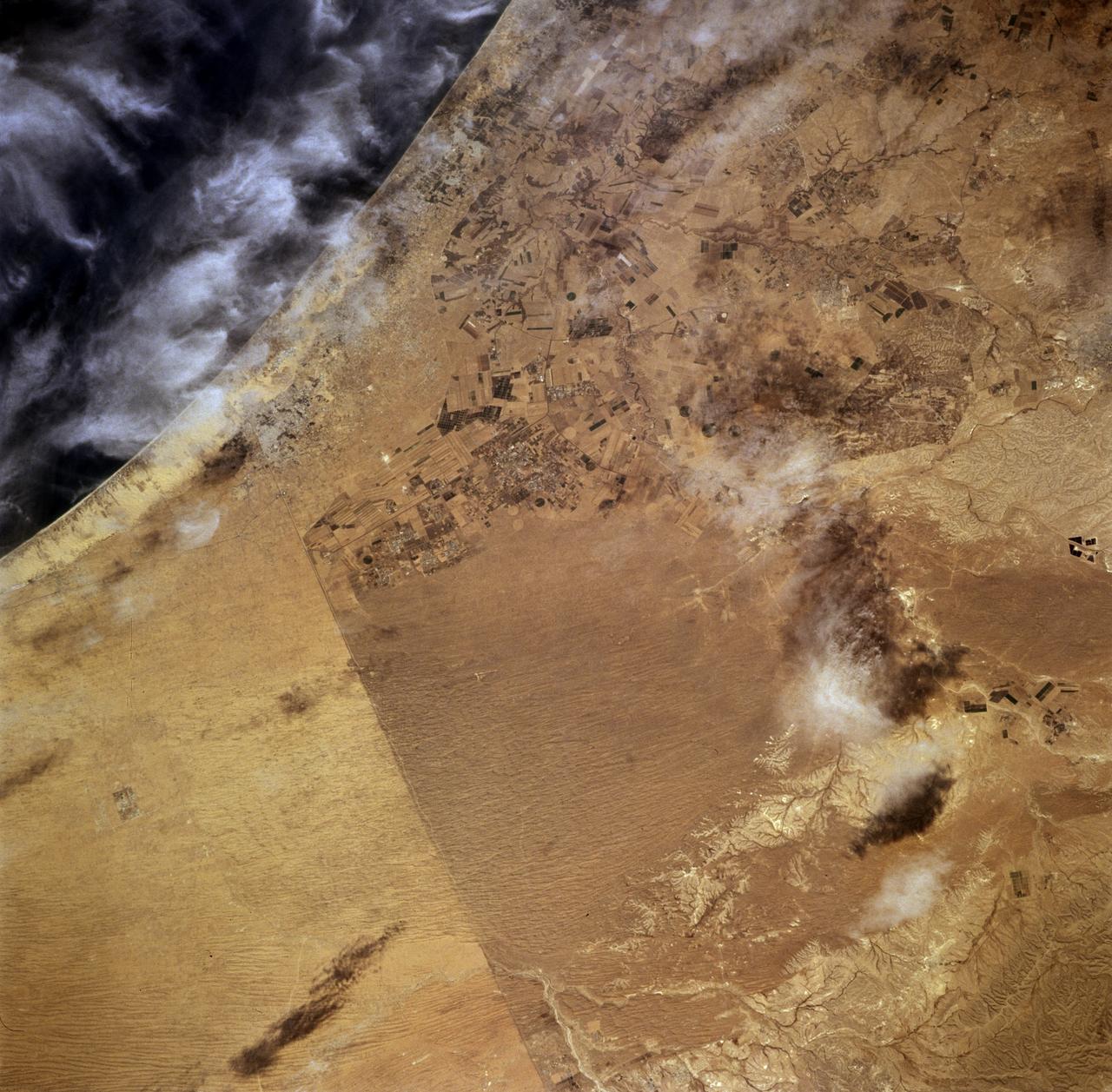 STS073-708-089 (26 October 1995) --- As evidenced by this 70mm photograph from the Earth-orbiting Space Shuttle Columbia, international borders have become easier to see from space in recent decades.  This, according to NASA scientists studying the STS-73 photo collection, is particularly true in arid and semi-arid environments.  The scientists go on to cite this example of the razor-sharp vegetation boundary between southern Israel and Gaza and the Sinai.  The nomadic grazing practices to the south (the lighter areas of the Sinai and Gaza, top left) have removed most of the vegetation from the desert surface.  On the north side of the border, Israel uses advanced irrigation techniques in Israel, mainly &quot;trickle irrigation&quot; by which small amounts of water are delivered directly to plant roots.  These water-saving techniques have allowed precious supplies from the Jordan River to be used on farms throughout the country.  Numerous fields of dark green can be seen in this detailed view.  Scientists say this redistribution of the Jordan River waters has increased the Israeli vegetation cover to densities that approach those that may have been common throughout the Mid-East in wetter early Biblical times.  A small portion of the Mediterranean Sea appears top right.