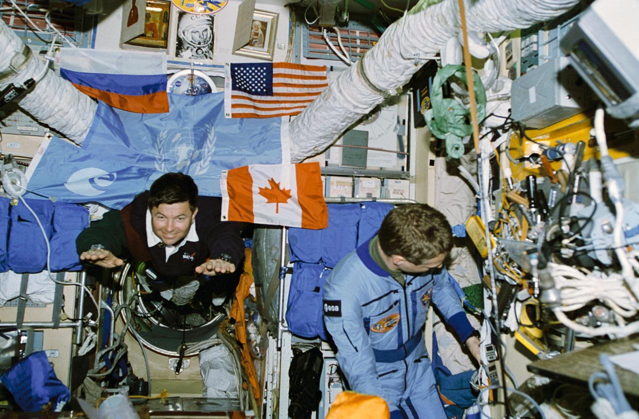 STS074-331-036 (12-20 Nov 1995) --- Astronaut Kenneth D. Cameron floats into the Core Module of Russia?s Mir Space Station.  The European Space Agency?s (ESA) Thomas Reiter checks out an array of tools.  With five NASA astronauts aboard the Space Shuttle Atlantis, the flight began with a November 12, 1995, launch from Kennedy Space Center (KSC) and ended with landing there on November 20, 1995.  The crew members were astronauts Cameron, mission commander; James D. Halsell, Jr., pilot; William S. McArthur, Jr., Jerry L. Ross and Canadian astronaut Chris A. Hadfield, all mission specialists.  On November 15, 1995, the Space Shuttle Atlantis docked with the Mir Space Station, on which the NASA astronauts joined the Mir-20 crew.  The Mir-20 crew is composed of cosmonauts Yuriy P. Gidzenko, commander; and Sergei V. Avdeyev, engineer; along with Reiter, cosmonaut researcher.  Joint activities on the Mir and the Space Shuttle Atlantis ended November 18, 1995, when the two spacecraft separated.