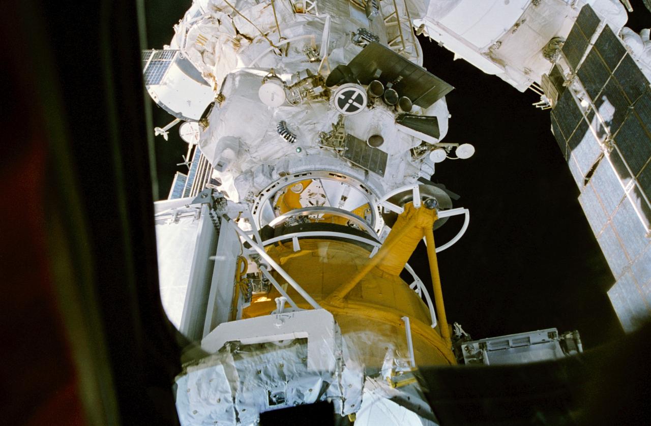 STS074-332-029 (15 Nov 1995) --- A 35mm camera aimed through the Space Shuttle Atlantis? aft windows captured rendezvous and docking operations with the Space Shuttle Atlantis and Russia?s Mir Space Station in Earth-orbit.  The new Docking Module (DM), carried into space by the Atlantis is about to contact Kristall on the cluster of Mir components.  The flight began with a November 12, 1995, launch from Kennedy Space Center (KSC) and ended with landing there on November 20, 1995.  The crew members were astronauts Kenneth D. Cameron, mission commander; James D. Halsell, Jr., pilot; William S. McArthur, Jr., Jerry L. Ross and Canadian astronaut Chris A. Hadfield, all mission specialists.  The Mir-20 crew is composed of cosmonauts Yuriy P. Gidzenko, commander; and Sergei V. Avdeyev, engineer; along with the European Space Agency?s (ESA) Thomas Reiter, cosmonaut researcher.  Joint activities on the Mir and the Space Shuttle Atlantis ended on November 18, 1995, when the two spacecraft separated.