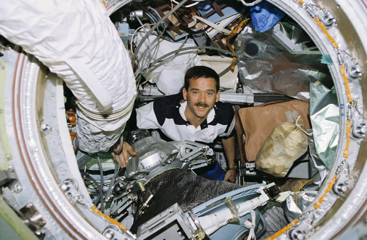 STS074-344-003 (12-20 Nov 1995) --- Astronaut Chris A. Hadfield makes his way among supplies and docking hardware onboard Russia?s Mir Space Station.  With five NASA astronauts aboard the Space Shuttle Atlantis, the flight began with a November 12, 1995, launch from Kennedy Space Center (KSC) and ended with landing there on November 20, 1995.  The STS-74 crew members were astronauts Kenneth D. Cameron, mission commander; James D. Halsell Jr., pilot; William S. McArthur Jr., Jerry L. Ross and Canadian astronaut Hadfield, all mission specialists.  On November 15, 1995, the Space Shuttle Atlantis docked with Russia?s Mir Space Station, on which the NASA astronauts joined the Mir-20 crew.  The Mir-20 crew is composed of cosmonauts Yuriy P. Gidzenko, commander; and Sergei V. Avdeyev, engineer; along with the European Space Agency?s (ESA) Thomas Reiter, cosmonaut researcher.  Joint activities on the Mir Space Station and the Space Shuttle Atlantis ended on November 18, 1995, when the two spacecraft separated.