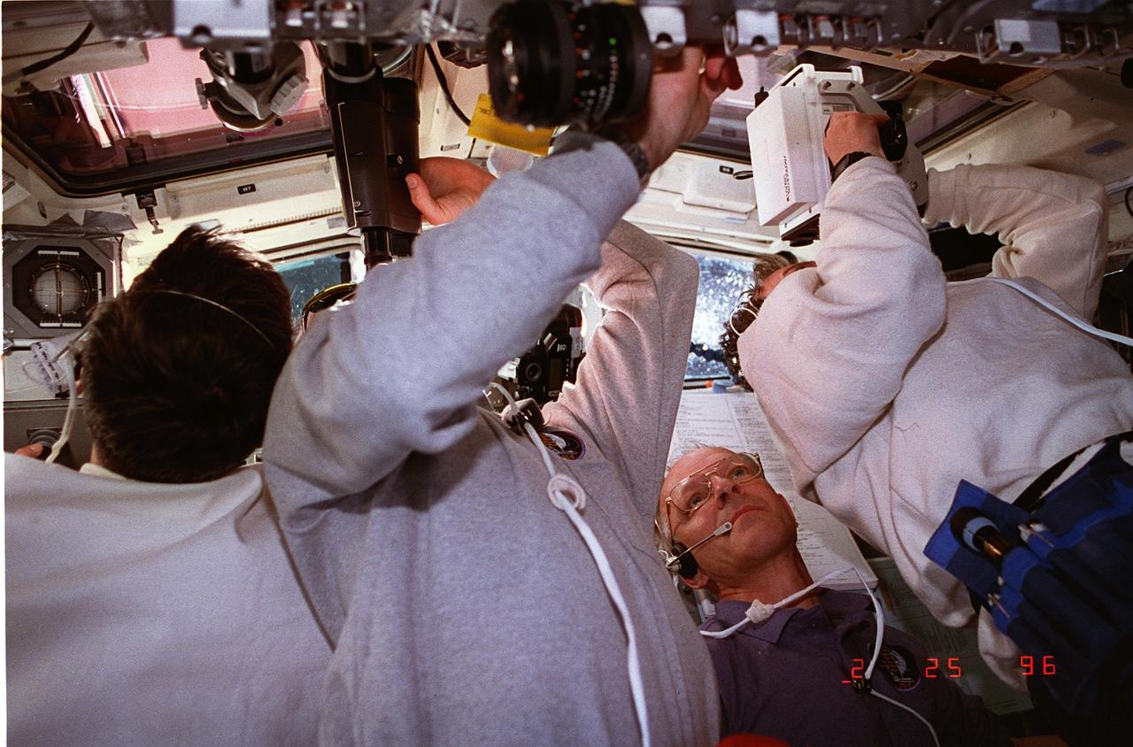 STS075-328-026 (25 Feb. 1996) --- Astronaut Claude Nicollier is the only clearly identifiable crewmember in this scene on the aft flight deck, captured during the busy chores associated with deployment of the Tethered Satellite System (TSS). The seven member crew was launched aboard the space shuttle Columbia on Feb. 22, 1996, and landed on March 9, 1996.  Crewmembers were Andrew M. Allen, mission commander; Scott J. Horowitz, pilot; Franklin R. Chang-Diaz, payload commander; and Maurizio Cheli, European Space Agency (ESA); Jeffrey A. Hoffman and Nicollier, ESA, all mission specialists; along with payload specialist Umberto Guidoni of the Italian Space Agency (ASI).