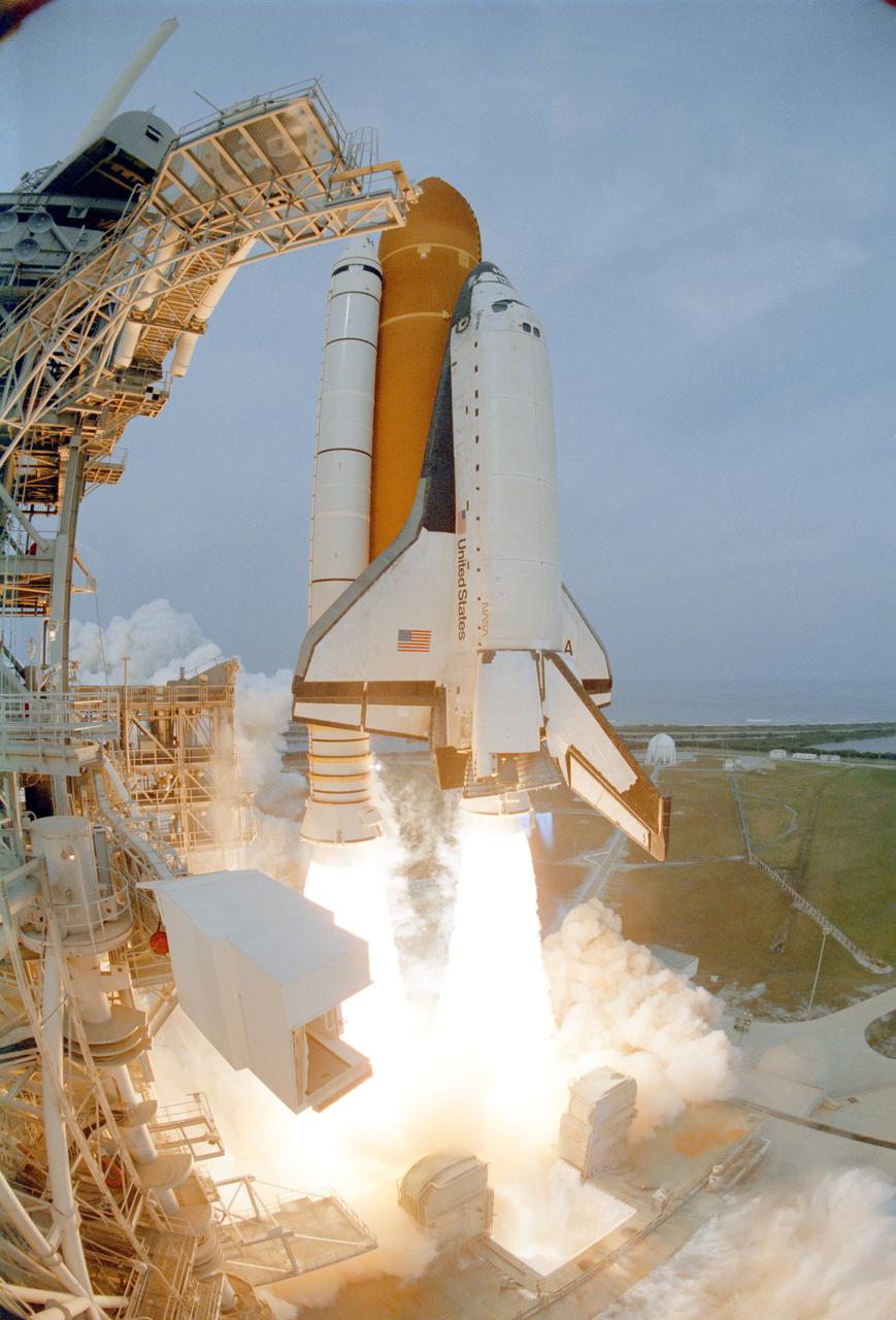 STS075-S-004 (22 Feb. 1996) --- The space shuttle Columbia clears the tower to begin the mission.  The liftoff occurred on schedule at 3:18:00 p.m. (EST), Feb. 22, 1996.  Visible at left is the White Room on the orbiter access arm through which the flight crew had entered the orbiter. Onboard Columbia for the scheduled two-week mission were astronauts Andrew M. Allen, commander; Scott J. Horowitz, pilot; Franklin R. Chang-Diaz, payload commander; and astronauts Maurizio Cheli, Jeffrey A. Hoffman and Claude Nicollier, along with payload specialist Umberto Guidoni.  Cheli and Nicollier represent the European Space Agency (ESA), while Guidoni represents the Italian Space Agency (ASI).