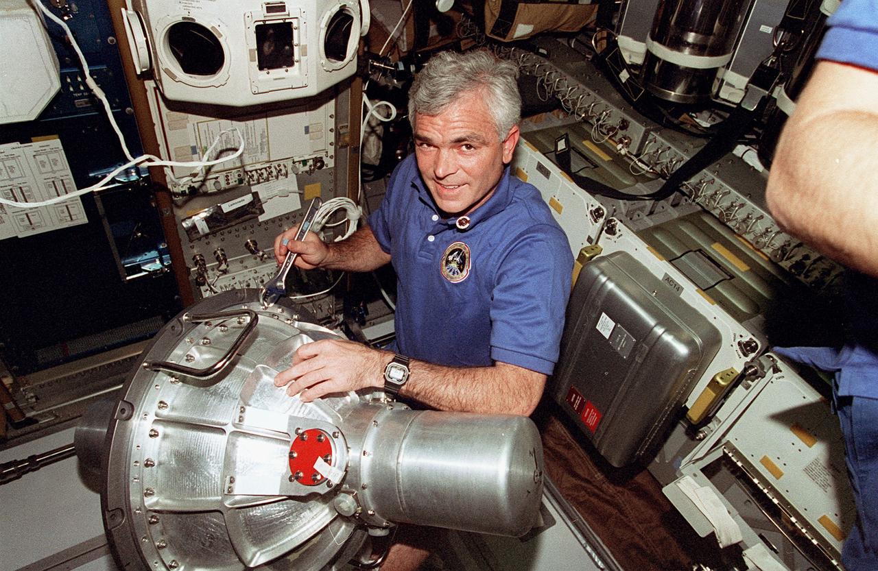 STS076-323-034 (22 - 31 March 1996) --- Astronaut Michael R. (Rich) Clifford, mission specialist, prepares to move a gyrodyne from the Space Shuttle Atlantis onto Russia's Mir Space Station.  The gyrodyne was later installed in the Base Block Module onboard Mir.