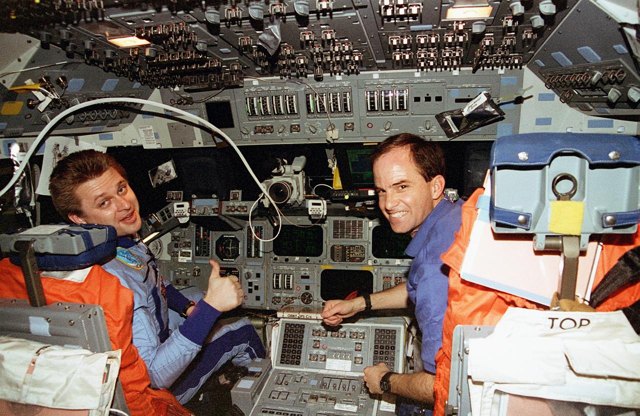 STS076-341-002 (22-31 March 1996)--- As astronaut Kevin P. Chilton looks on, cosmonaut Yury I. Onufrienko gives a thumbs up gesture, signifying successful docking operations between Russia's Mir Space Station and the Space Shuttle Atlantis.  The Mir-21 and STS-76 commanders, respectively, earlier headed up the in-space effort which made possible the third link-up of Mir and Atlantis in Earth-orbit.  With the delivery of astronaut Shannon W. Lucid to the Mir, the Mir-21 crew grew from two to three, as the mission specialist temporarily became a cosmonaut guest researcher.  She is to spend approximately 140 days on Mir before returning to Earth.