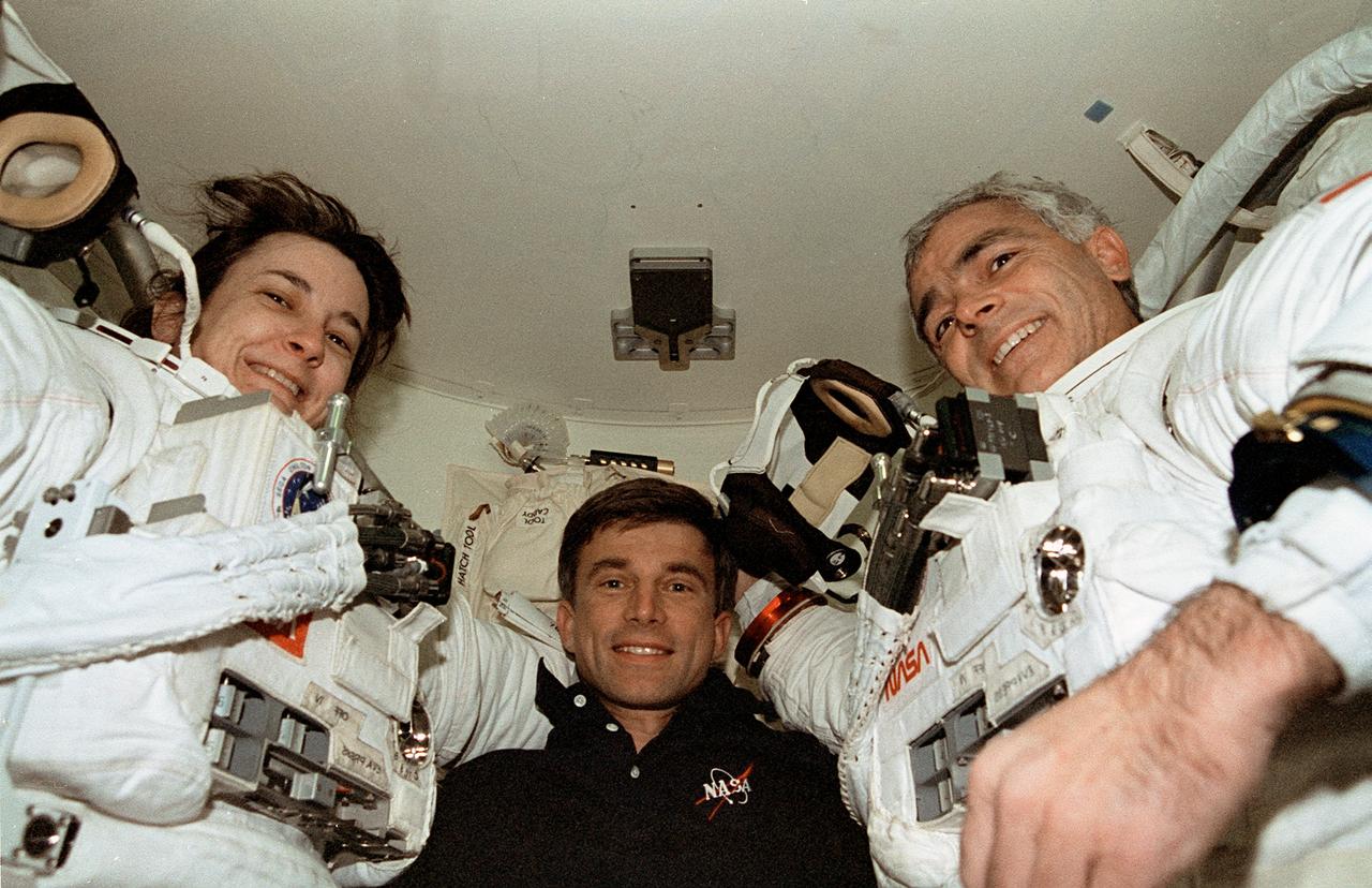 STS076-342-027 (27 March 1996) --- Astronaut Ronald M. Sega, center, shares the airlock of the Space Shuttle Atlantis with the two assigned space walkers for STS-76 - astronauts Linda M. Godwin and Michael R. (Rich) Clifford.  Sega, the payload commander, assisted the two mission specialists in preparing for the first ever Extravehicular Activity (EVA) to take place while the Space Shuttle was docked with Russia's Mir Space Station.