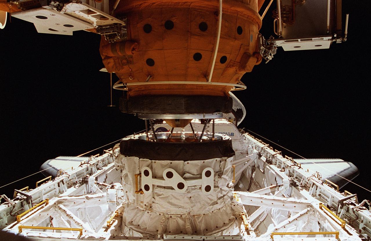 STS076-344-003 (24 March 1996) --- The Space Shuttle Atlantis Orbiter Docking System (ODS) and the Docking Module (DM) on Russia's Mir Space Station appear near the center of this frame, as the Atlantis and Mir link in Earth-orbit, at about 160 nautical miles altitude.  The STS-76 crew later diminished by one and the Mir-21 crew grew by one, as astronaut Shannon W. Lucid, mission specialist, went aboard the Mir Space Station and became a cosmonaut guest researcher.  She is scheduled to return to Earth in about 140 days.