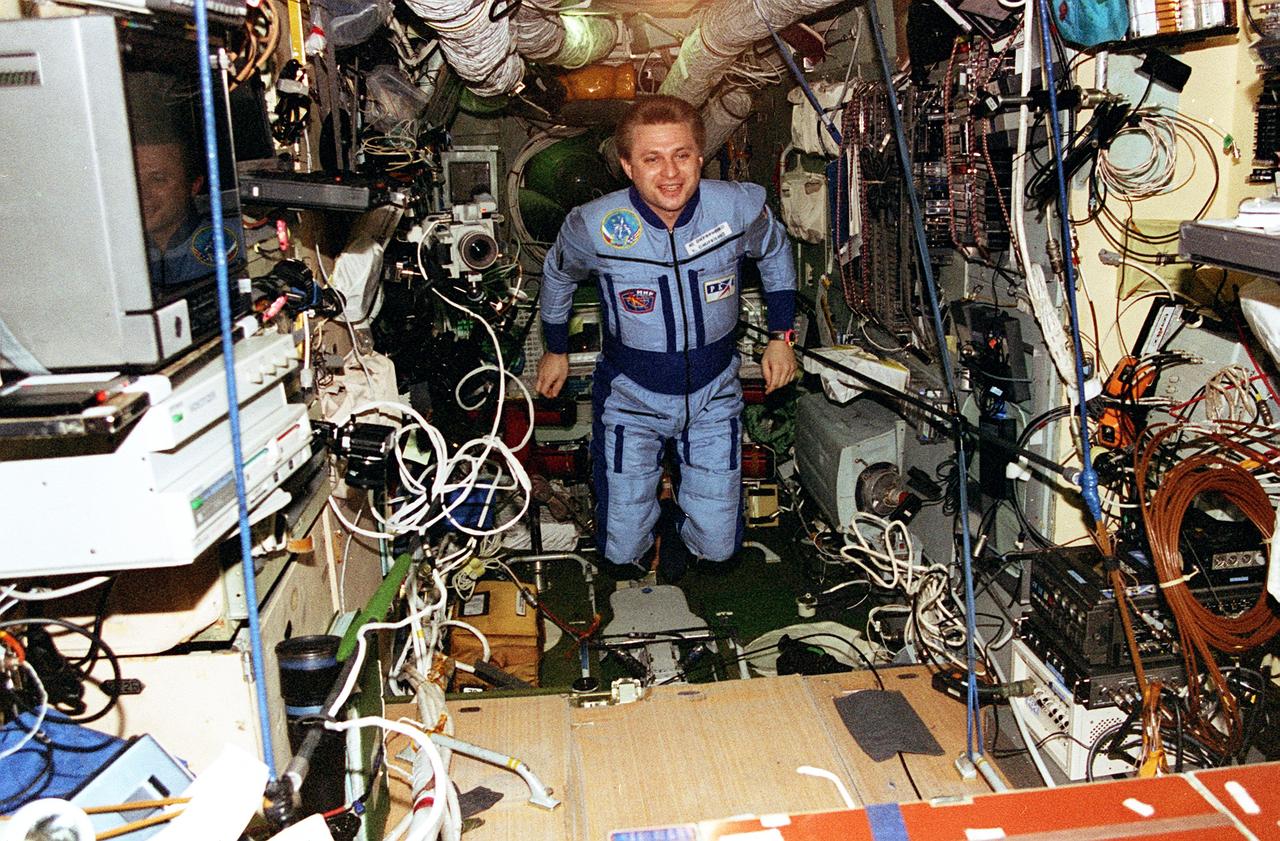STS076-344-034 (22-31 March 1996) --- Cosmonaut Yury I. Onufrienko, commander for the Mir-21 mission, floats through the Base Block Module on Russia's Mir Space Station.  The photograph was taken with a 35mm camera by one of the STS-76 Space Shuttle Atlantis crew members, aboard Mir for a brief visit following the delivery of astronaut Shannon W. Lucid, cosmonaut guest researcher, during the third docking mission.