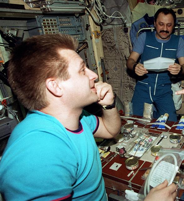Crew activity in Mir Space Station and Shuttle Atlantis