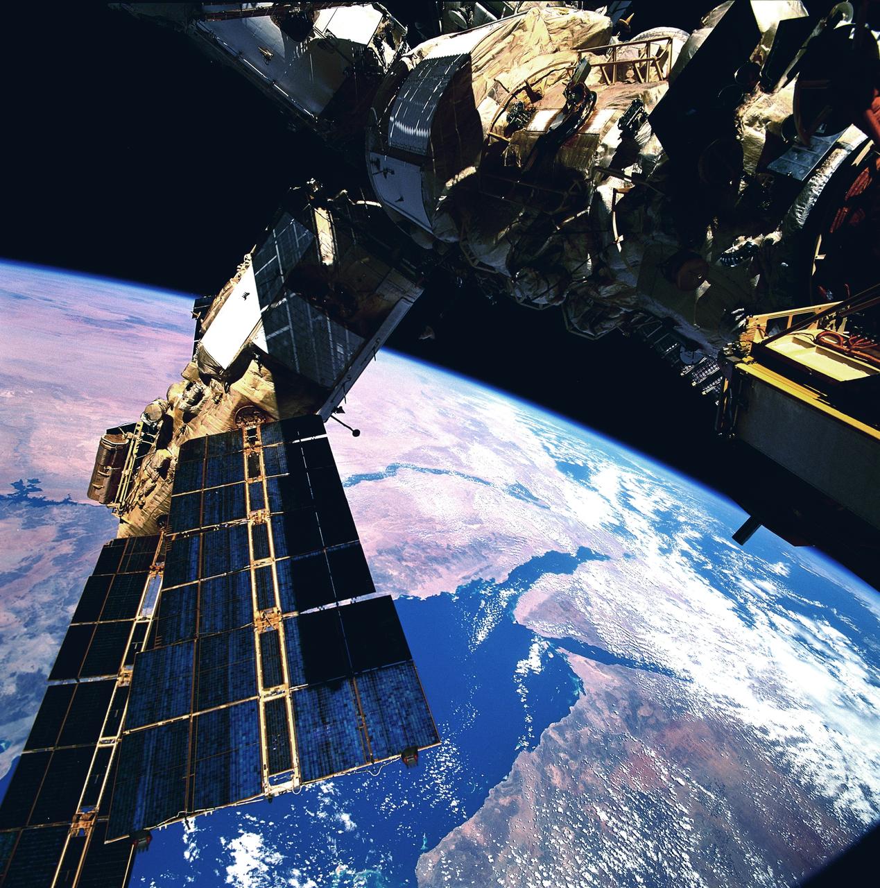 STS076-734-084 (22 - 31 March 1996) --- A clear scene of the Sinai Peninsula and the Nile River Delta forms the backdrop for this 70mm scene of Russia's Mir Space Station, as photographed from the aft flight deck of the Space Shuttle Atlantis.  Atlantis docked with Mir on March 23, 1996, and remained linked until March 28, 1996.  Astronaut Shannon W. Lucid transferred from the STS-76 crew to the Mir-21 crew, which grew from two to three.  She will remain aboard Mir for approximately 140 days, as a cosmonaut guest researcher.