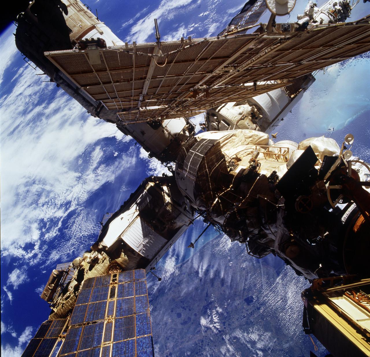 STS076-736-017 (22-31 March 1996) --- Southern Florida and the Atlantic coast form the backdrop for this picture showing most of the components of Russia's Mir Space Station.  The photograph was taken from the aft flight deck of the Space Shuttle Atlantis.  Mir and Atlantis docked on March 23, 1996, and separated on March 28, 1996.  Cape Canaveral and the Kennedy Space Center (KSC) are below one of Mir's solar array panels in the upper left quadrant of the frame.