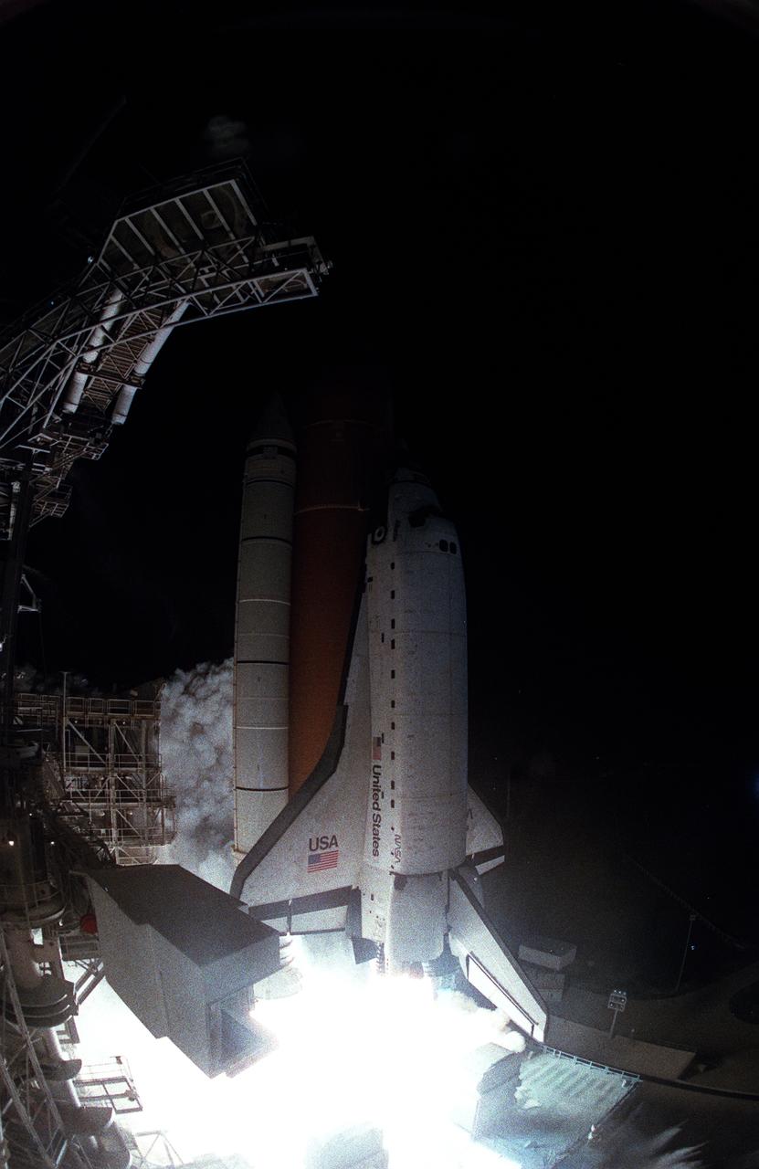 STS076-S-008 (22 March 1996) --- As represented in this fish-eye view from the Kennedy Space Center's (KSC) Launch Pad 39B, the space shuttle Atlantis heads toward Earth-orbit and an eventual docking with Russia's Mir Space Station. Mir has been in space for ten years and a two man crew (Mir-21) currently awaits the arrival of Atlantis. The on-time launch occurred at 3:13:04 a.m. (EST) on March 22, 1996. Onboard for STS-76 are astronauts Kevin P. Chilton, Richard A. Searfoss, Ronald M. Sega, Michael R. (Rich) Clifford, Linda M. Godwin and Shannon W. Lucid. Lucid will remain onboard Mir for just under five months time. Photo credit: NASA or National Aeronautics and Space Administration