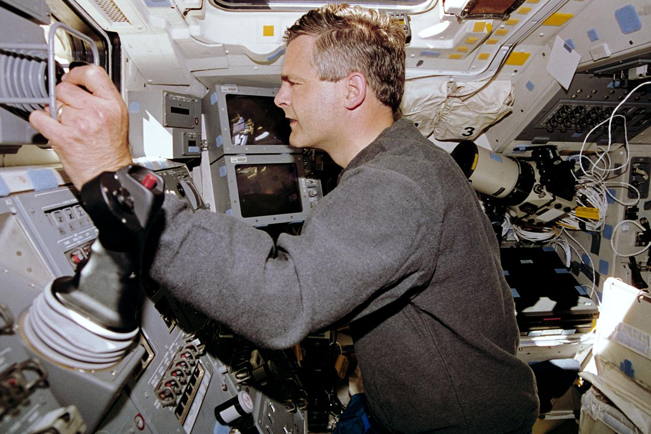 STS077-307-017 (19-29 May 1996) --- Astronaut Marc Garneau, mission specialist, is pictured at the controls for the Remote Manipulator System (RMS) on the aft flight deck of the Space Shuttle Endeavour.  Garneau, representing the Canadian Space Agency (CSA), and five other astronauts went on to spend almost ten days aboard Endeavour in support of the Spacehab 4 mission and a number of other payloads.