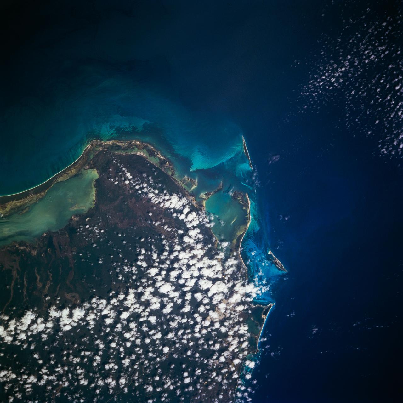 STS077-704-010 (19-29 May 1996) --- The northeastern tip of the Yucatan Peninsula is visible in this Earth scene.  The eastern coast of the Yucatan Peninsula is characterized by bluffs, bays, and islands.  Isla Mujeres is one of the larger islands off the eastern coast where a tourism industry is being developed.  The different shades of blue along the coast is an indication of water depth, with the lighter shades representing more shallow water.