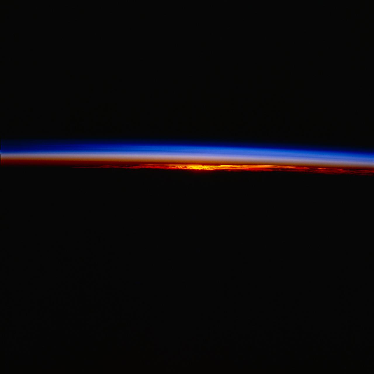 STS077-704-045 (19-29 May 1996) --- As the Space Shuttle Endeavour goes into darkness, the sun setting behind gave the astronaut crew aboard Endeavour a great chance to look at the atmospheric limb.  The colors of the atmospheric limb are created by the sunlight being reflected off the gases of the upper atmosphere.  As the photograph shows, the Earth?s weather and clouds take up only a small part of the whole atmosphere.