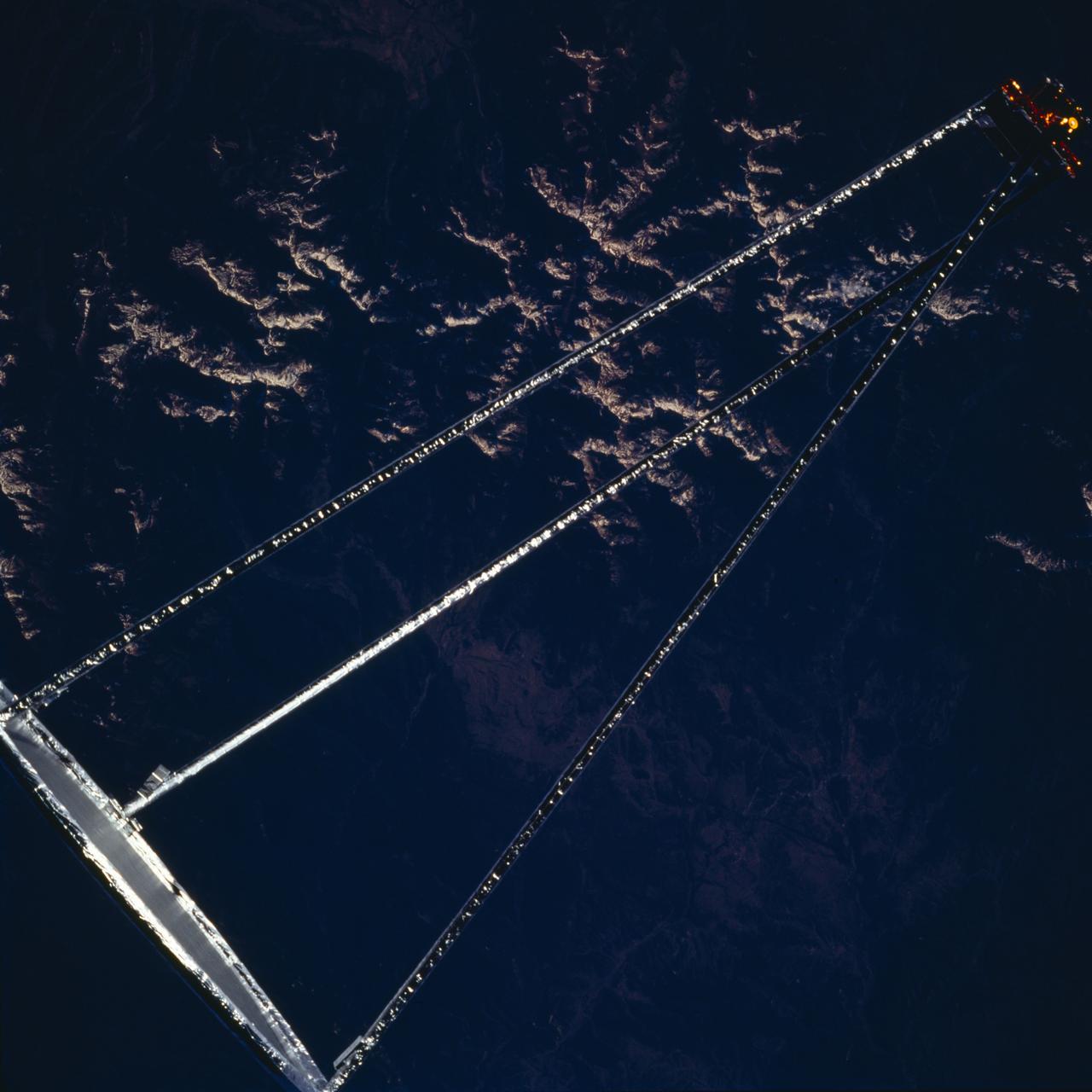 STS077-705-051 (20 May 1996) --- Following its deployment from the Space Shuttle Endeavour and its subsequent inflation process, the Spartan 207/Inflatable Antenna Experiment (IAE) payload is backdropped over mountains.  The view was photographed with a handheld 70mm camera during the first full day of orbital operations by the six-member crew.  Managed by Goddard Space Flight Center (GSFC), Spartan is designed to provide short-duration, free-flight opportunities for a variety of scientific studies.  The Spartan configuration on this flight is unique in that the IAE is part of an additional separate unit which is ejected once the experiment is completed.  The IAE experiment will lay the groundwork for future technology development in inflatable space structures, which will be launched and then inflated like a balloon on-orbit.