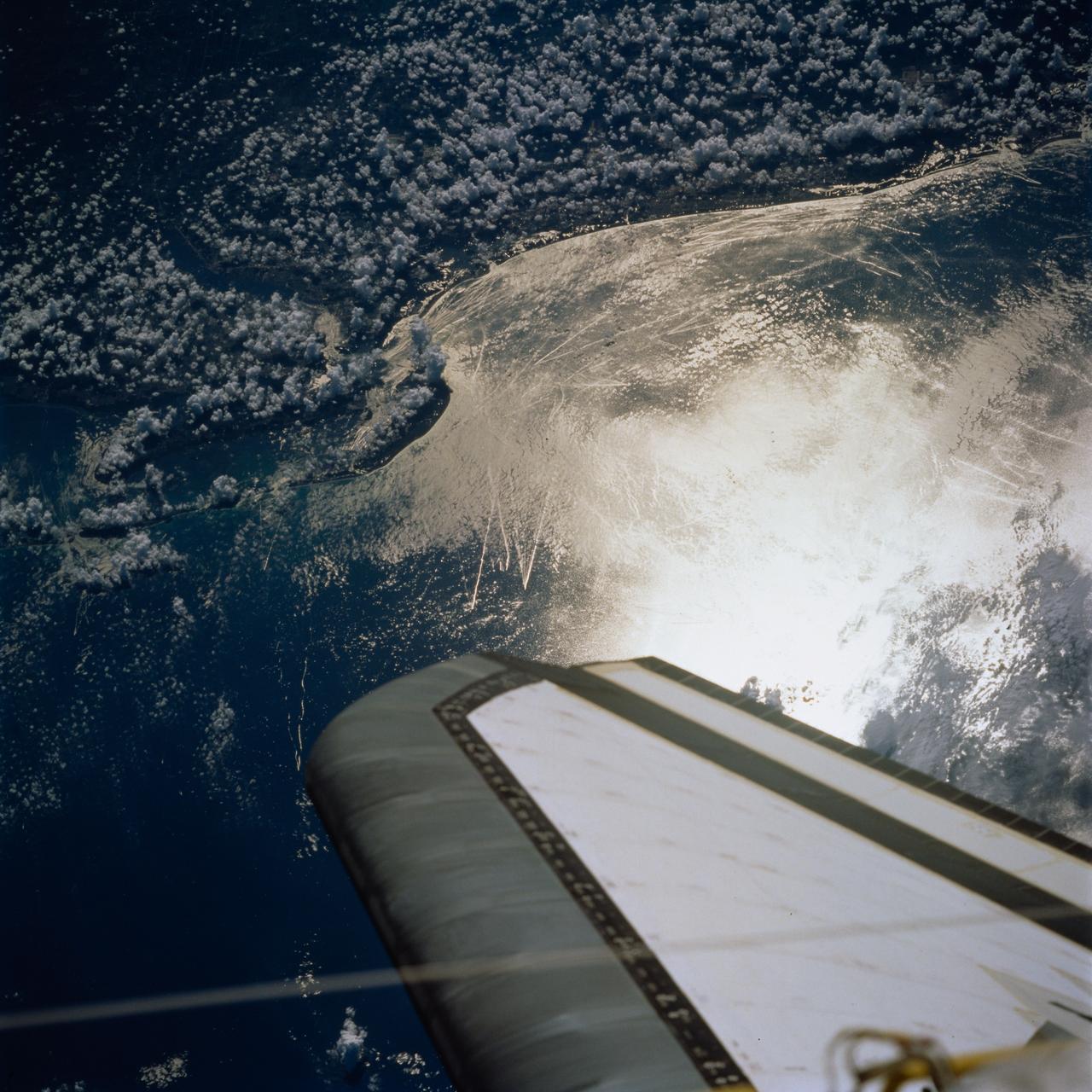 STS077-744-046 (19-29 May 1996) --- This view shows ship wakes off the coast of Fort Myers, Florida.  The Sun glint reflecting off the ocean surfaces allowed man-made features to be seen and photographed by the astronaut crew members.  When a ship or boat goes through the water it disturbs the surface of the water which causes the Sun?s rays to reflect back differently than the surrounding waters.  Photographed on a weekend, this image illustrates how popular recreational boating is around the Fort Myers area.