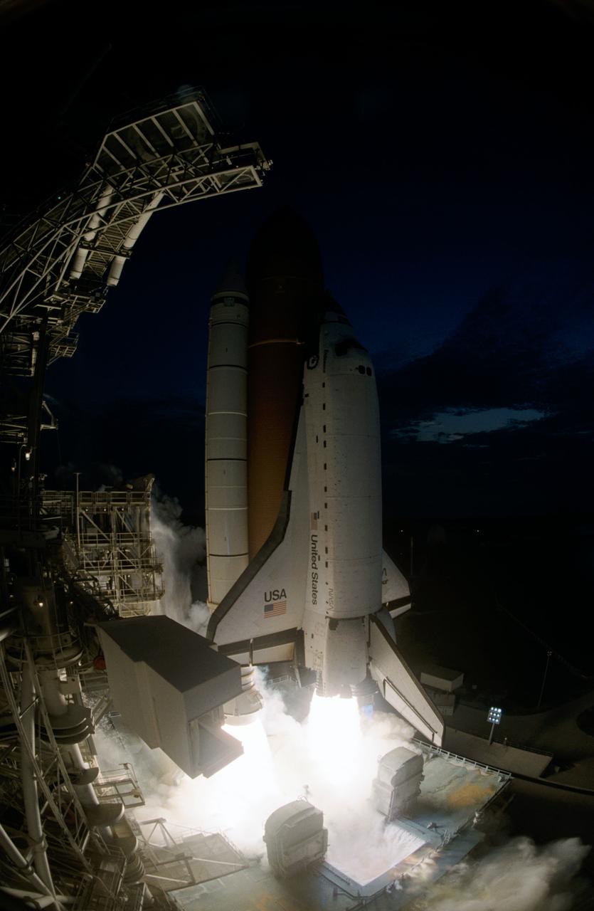 STS077-S-005 (19 May 1996) --- As seen through the ?fish-eye? lens of a 35mm camera at the service structure, the Space Shuttle Endeavour lifts off with six astronauts aboard.  It was headed toward the fourth NASA Space Shuttle mission of the year.  The launch occurred at 6:30:00 a.m. (EDT), May 19, 1996.  Leading the crew onboard is astronaut John H. Casper, mission commander.  Other crew members are astronauts Curtis L. Brown, Jr., pilot; along with Daniel W. Bursch, Mario Runco, Jr., Andrew S. W. Thomas and Marc Garneau, all mission specialists.  Garneau represents the Canadian Space Agency (CSA).  During the approximately 10-day mission, the crew will perform a variety of payload activities, including microgravity research aboard the Spacehab 4 Module, deployment and retrieval of the Spartan 207 and deployment and rendezvous with the Passive Aerodynamically-Stabilized Magnetically-Damped Satellite (PAMS).