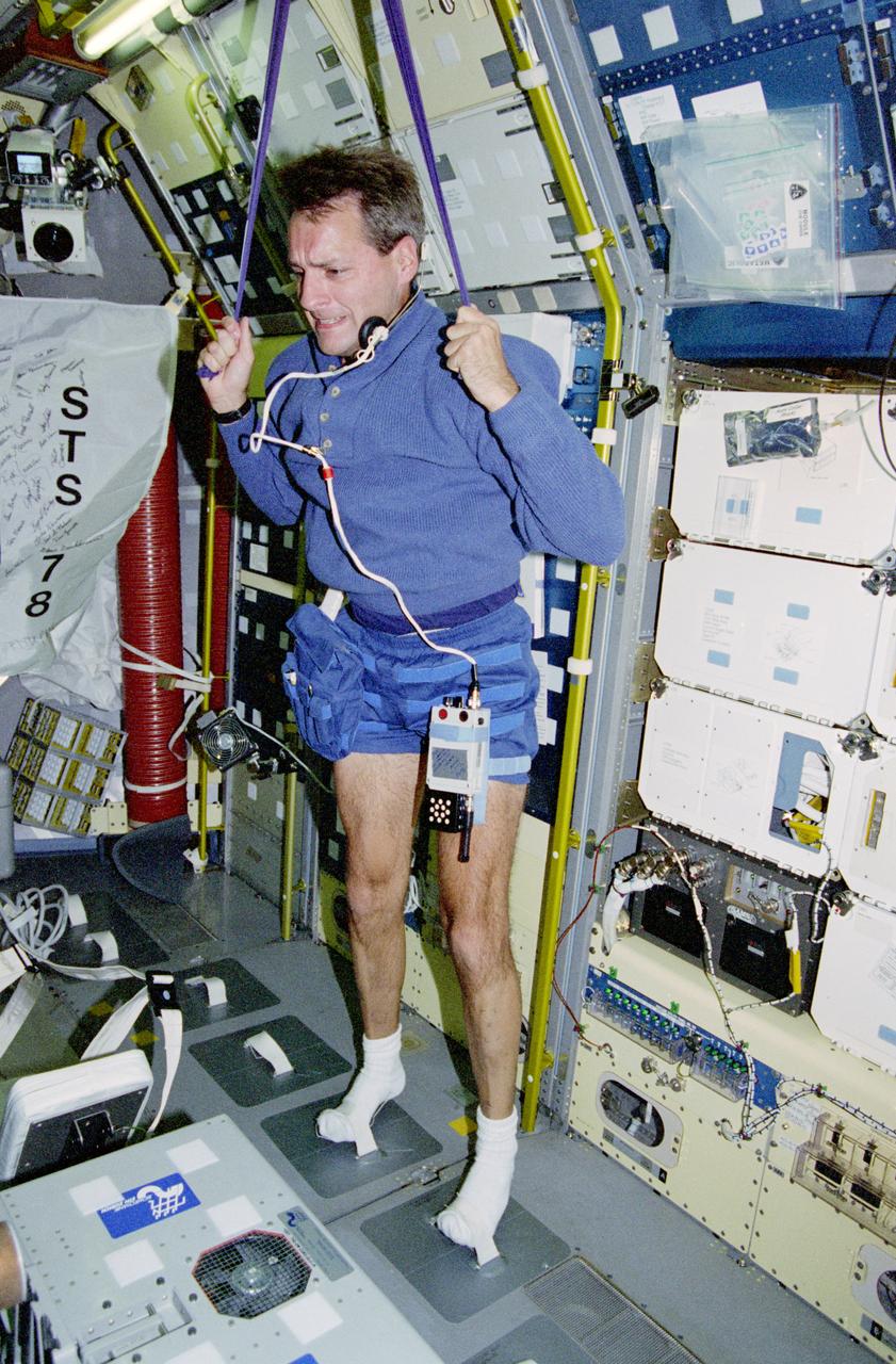 STS078-305-022 (20 June-7 July 1996) --- Astronaut Richard M. Linnehan, mission specialist, works out in the Life and Microgravity Spacelab (LMS-1) Science Module aboard the Earth-orbiting Space Shuttle Columbia.  With an almost 17-day mission away from Earth?s gravity, crew members maintained an exercise regimen above and beyond their assigned LMS-1 duty assignments.