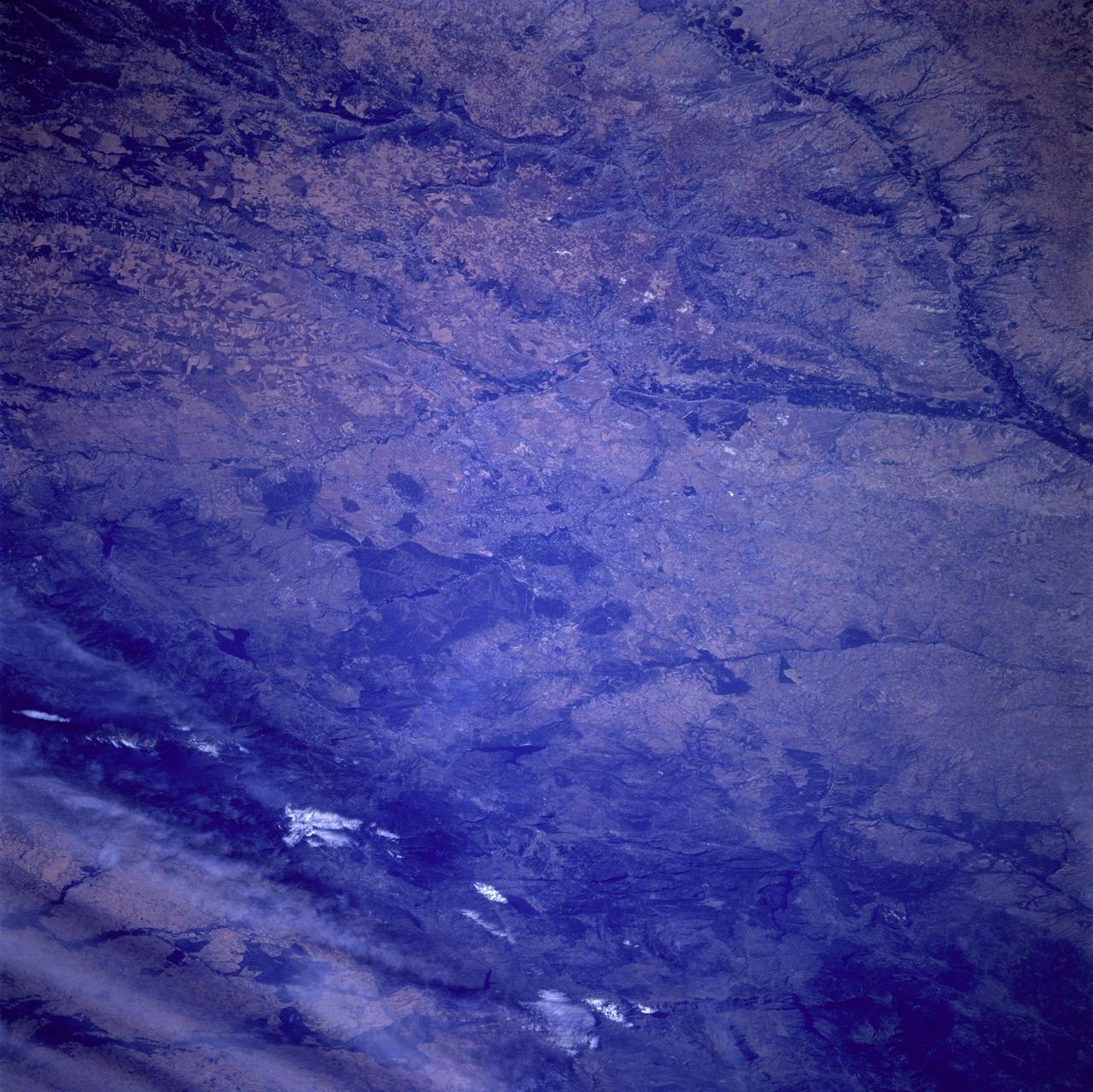 STS078-742-051 (20 June - 7 July 1996) --- One of the crew members aboard the Space Shuttle Columbia in Earth-orbit photographed this space to Earth view of Madrid, the capital of Spain as well as that country&#0146;s largest city.  Madrid represents the national center of arts and industry.  It is located in the center of the photo and is difficult to see because it blends into the surrounding colors.  It was in 1607 that Philip III officially made the city the national capital, a status it has retained ever since.  Under the patronage of Philip and his successors, Madrid developed into a city of curious contrasts, preserving its old, overcrowded center, around which developed palaces, convents, churches, and public buildings.  Madrid lies almost exactly at the geographical heart of the Iberian Peninsula, near the Carpetovetonica Range.  It is situated on an undulating plateau of sand and clay known as the Meseta (derived from the Spanish word mesa, or &quot;table&quot;) at an altitude of 2,100 feet (635 meters) above sea level, making it one of the highest capitals in Europe.  It is not on a major river, in the way that so many European cities are, but is on a smaller river, the Manzanares.