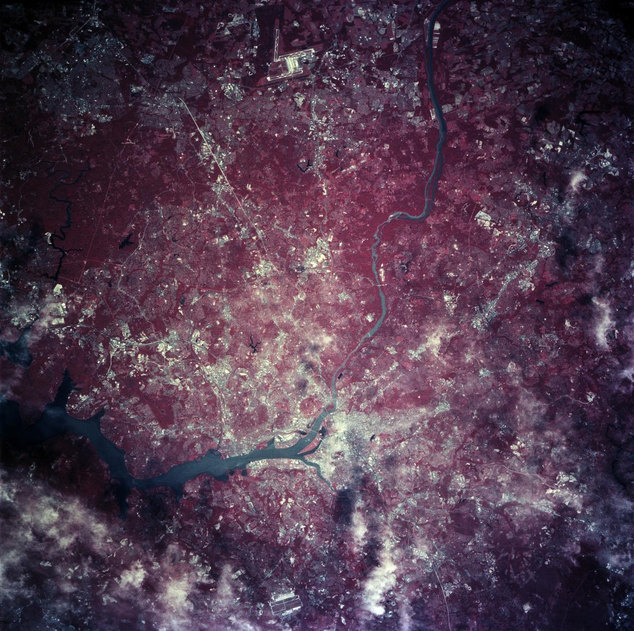 STS078-760-010 (20 June - 7 July 1996) --- As photographed with color infrared film by the crew of the Space Shuttle Columbia, the capital of the United States of America (the right of center) is located at the head of the navigable portion of the Potomac River.  The Potomac separates the capital from Virginia to the southwest.  It covers an area of 68-square-mile (177-square-kilometers).  Andrews Air Force Base is seen east southwest of Washington D.C. at the right edge of the photo.  Dulles International Airport is located west of the city on the left edge of the photo.  Green vegetation shows up as red in the color infrared image.