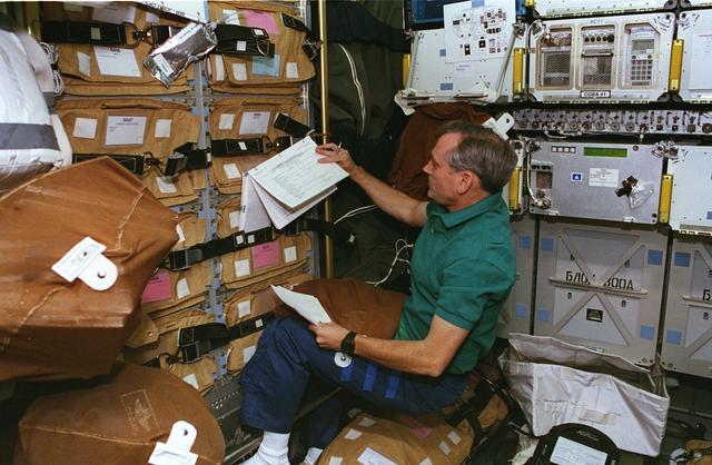 NASA image: STS-79 crewmembers preparing stowage for transfer