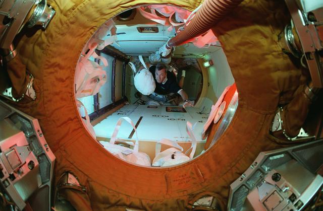 NASA image: Astronaut Wilcutt with water transfer bag in docking module