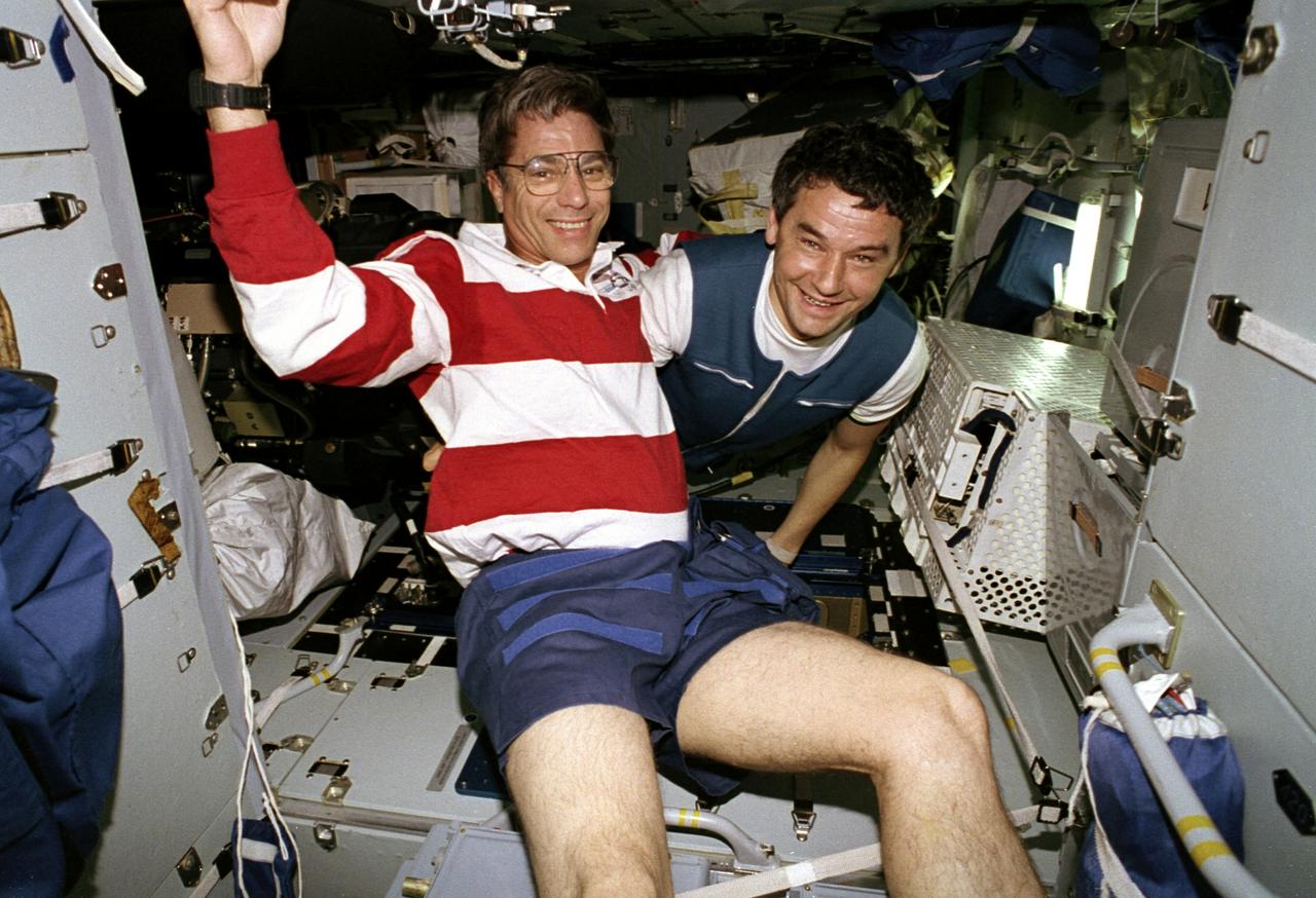 STS079-350-028 (16-26 Sept. 1996) --- Aboard Russian Mir Space Station's Spektr Module, astronaut John E. Blaha, now a cosmonaut guest researcher, visits with Valeri G. Korzun, his mission commander for Mir-22. This photograph is one of fifteen 35mm frames (along with four 70mm frames) of still photography documenting the activities of NASA's STS-79 mission, which began with a Sept. 16, 1996, liftoff from Launch Pad 39A the Kennedy Space Center (KSC) and ended with a landing at KSC on September 26, 1996.  Onboard for the launch were astronauts William F. Readdy, commander; Terrence W. Wilcutt, pilot; Blaha, Jerome (Jay) Apt, Thomas D. Akers and Carl E. Walz, all mission specialists.  On flight day 4, the crew docked with Mir.  Shannon W. Lucid, who had spent six months aboard Mir, switched cosmonaut guest researcher roles with Blaha. The latter joined fellow Mir-22 crewmembers Korzun, and Aleksandr Y. Kaleri, flight engineer.