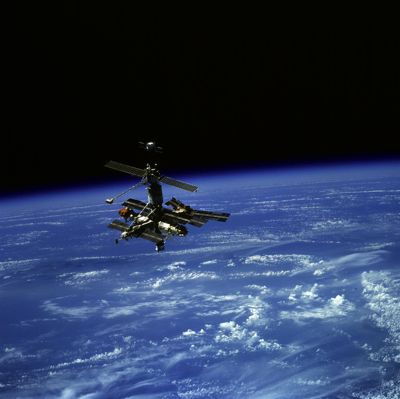 STS079-810-028 (24 Sept. 1996) --- Russia's Mir Space Station, backdropped over Earth's horizon,  was photographed by one of the STS-79 crew members aboard the space shuttle Atlantis as it performed its final fly around following undocking operations. The STS-79 flight began with a Sept. 16, 1996, liftoff from Launch Pad 39A at the Kennedy Space Center and ended with a landing at KSC on Sept. 26, 1996. Onboard for the launch were astronauts William F. Readdy, commander; Terrence W. Wilcutt, pilot; John E. Blaha, Jerome (Jay) Apt, Thomas D. Akers and Carl E. Walz, all mission specialists. On flight day four, the crew docked with Mir. Shannon W. Lucid, who had spent six months aboard Mir, switched cosmonaut guest researcher roles with Blaha. The latter joined fellow Mir-22 crew members Valeri G. Korzun, commander, and Aleksandr Y. Kaleri, flight engineer. Photo credit: NASA