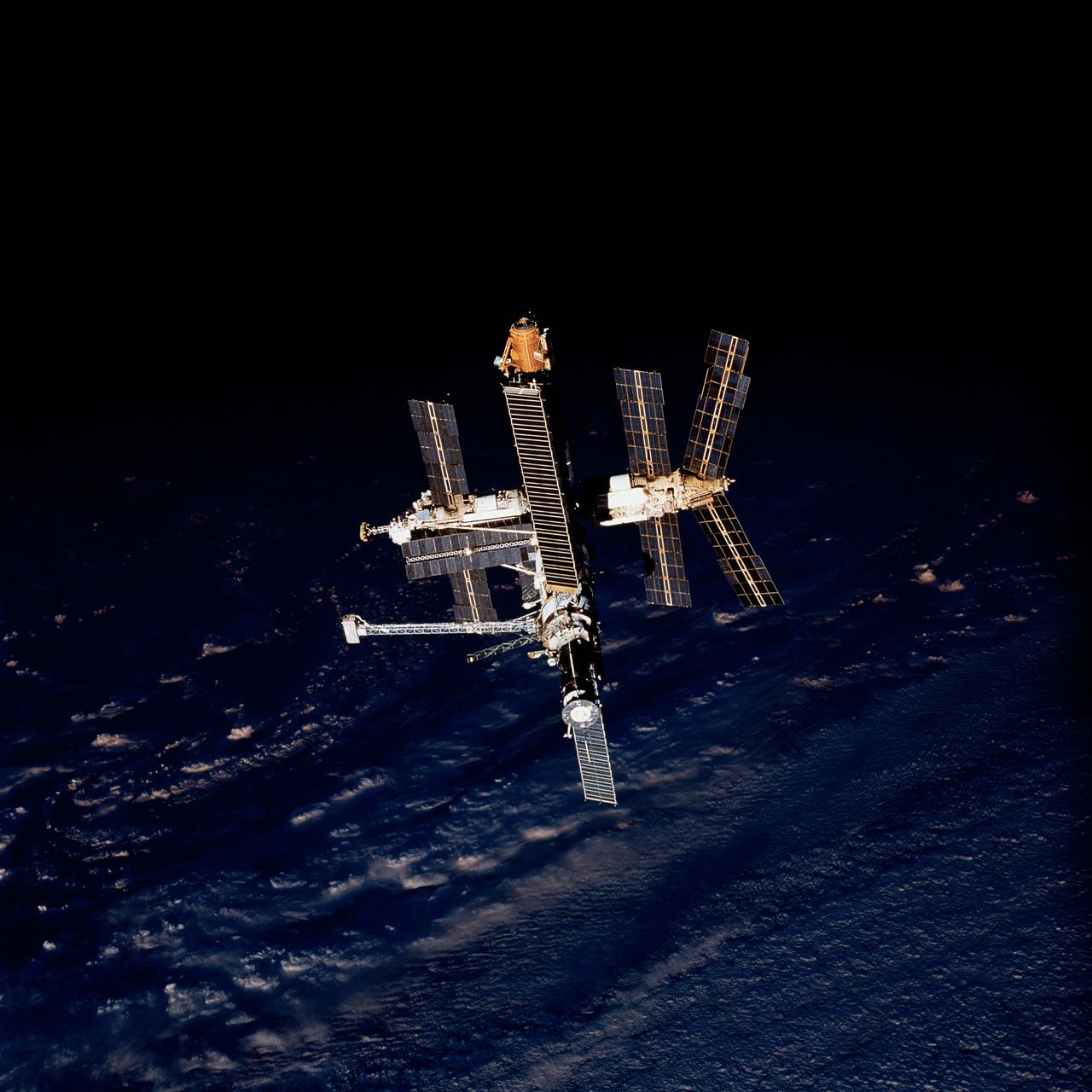 STS079-821-036 (16-26 Sept. 1996) --- Following the Space Shuttle Atlantis - Russian Mir Space Station undocking activities, a crew member captured this 70mm frame of Mir as the two crews shared their final common sunset scene.  This photograph is one of four 70mm frames (along with fifteen 35mm frames) of still photography documenting the activities of NASA's STS-79 mission, which began with a September 16, 1996, liftoff from Launch Pad 39A the Kennedy Space Center (KSC) and ended with a landing at KSC on September 26, 1996.  Onboard for the launch were astronauts William F. Readdy, commander; Terrence W. Wilcutt, pilot; John E. Blaha, Jerome (Jay) Apt, Thomas D. Akers and Carl E. Walz, all mission specialists.  On flight day 4, the crew docked with Mir.  Shannon W. Lucid, who had spent six months aboard Mir, switched cosmonaut guest researcher roles with Blaha.  The latter joined fellow Mir-22 crew members Valeri G. Korzun, commander, and Aleksandr Y. Kaleri, flight engineer.