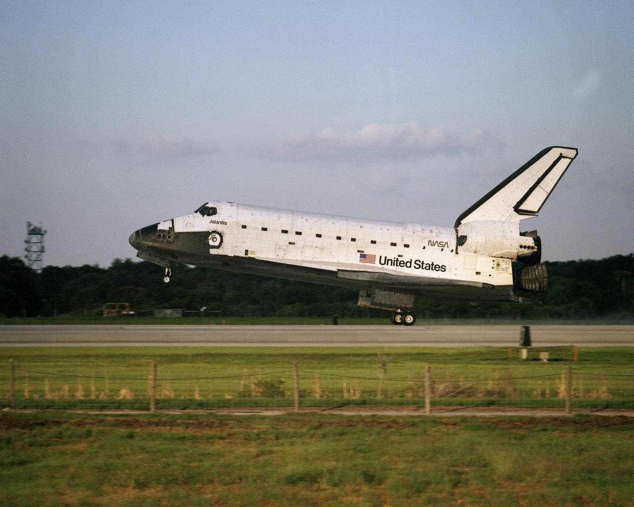 STS079-S-022 (26 Sept. 1996) --- The main landing gear of the space shuttle Atlantis touches down on Runway 15 at the Shuttle Landing Facility (SLF) at the Kennedy Space Center (KSC), bringing an end to the successful ten-day mission.  Landing occurred at 8:13:15 a.m. (EDT), Sept. 26, 1996.  The touchdown marked the end of 188 days in space for astronaut Shannon W. Lucid, following her in-space exchange with astronaut John E. Blaha, who is now aboard Russia's Mir Space Station. Returning along with Lucid were her STS-79 crew mates - astronauts William F. Readdy, commander; Terrence W. Wilcutt, pilot; and Thomas D. Akers, Jerome (Jay) Apt and Carl E. Walz, mission specialists.