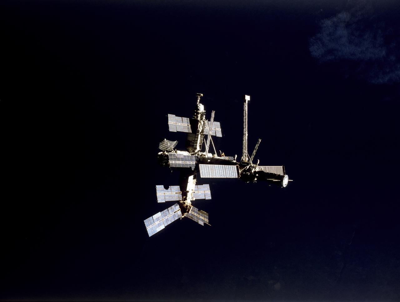 STS079-S-125 (16-26 Sept. 1996) --- Following undocking from the Space Shuttle Atlantis, Russia's Mir Space Station is backdropped against dark blue water on Earth, though it appears to be surrounded by the blackness of space. During the STS-79 mission, the crew used an IMAX camera to document Intravehicular Activities (IVA) aboard the Atlantis and the various Mir modules, as well as to record both docking and undocking activities through Atlantis' windows. NASA has flown IMAX camera systems on many Shuttle missions, including a special cargo bay camera's coverage of other recent Shuttle-Mir rendezvous and/or docking missions.