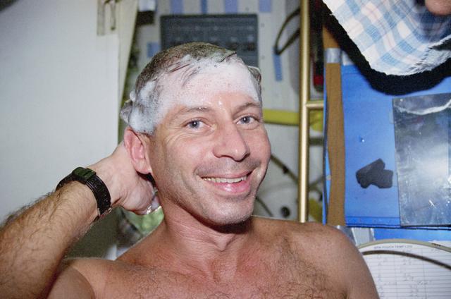NASA image: Cockrell washs hair and face