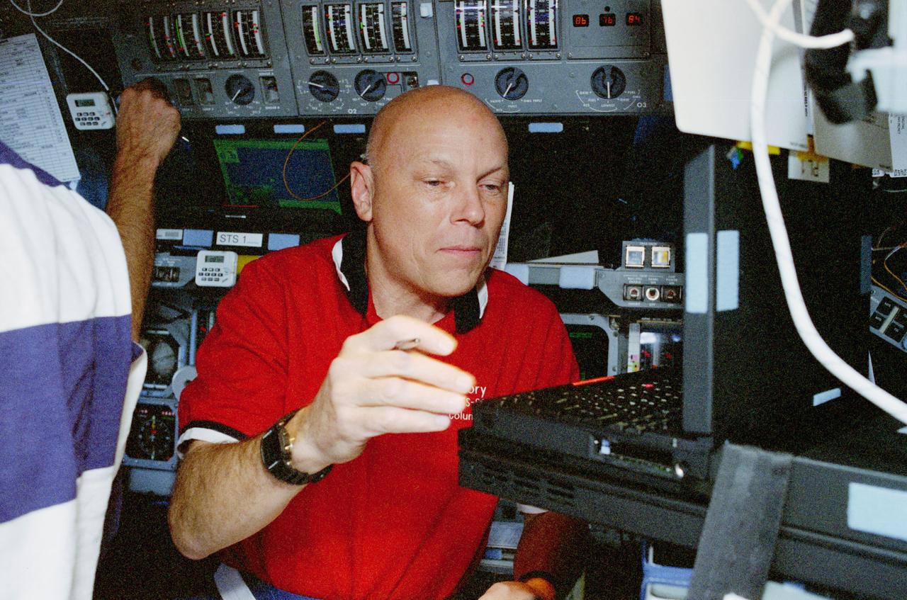 STS080-314-003 (19 Nov.-7 Dec. 1996) --- Astronaut Story Musgrave, STS-80 mission specialist, works with a pair of computers dedicated to Wake Shield Facility (WSF) operations onboard the space shuttle Columbia's flight deck. Musgrave marked his sixth appearance on a space shuttle flight during this duration record-setting space flight.