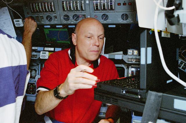 NASA image: WSF, Story Musgrave monitors the condition of the satellite